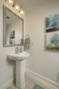 Well-Lit Bathroom Pedestal Sink and Mirror