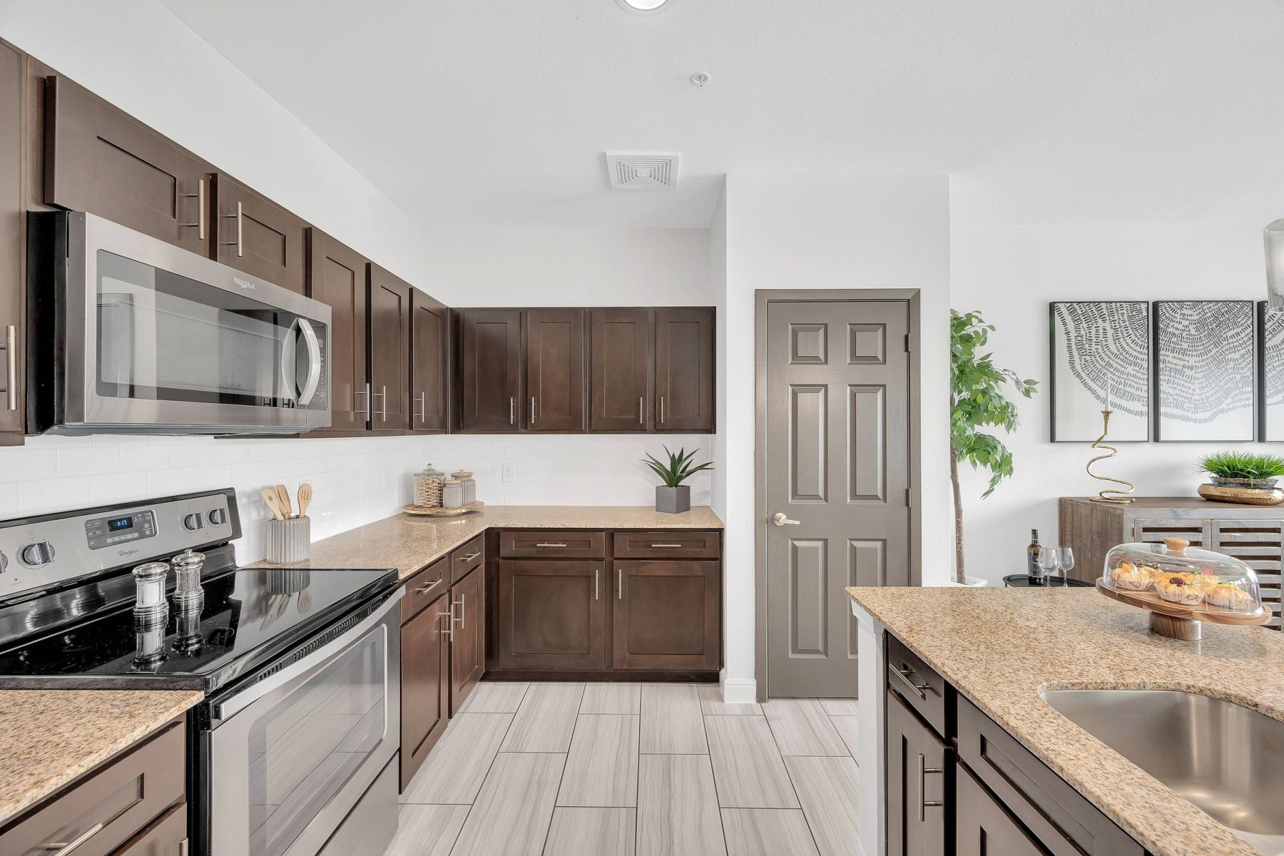 Luxury apartment kitchen with stainless steel appliances, granite countertops, and lots of storage space